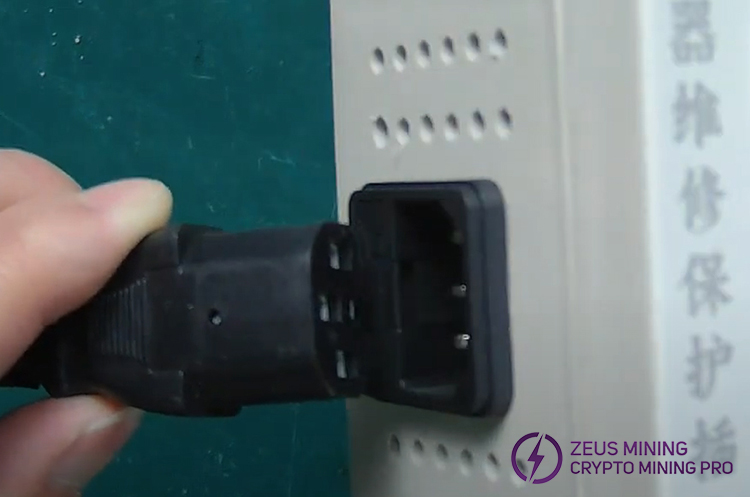 Insert the 220V AC plug